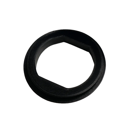 Black rubber gasket on a textured white background